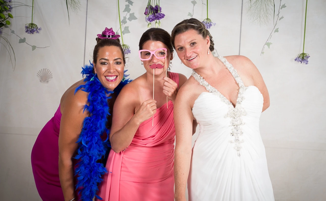 The bride and guests enjoying the photo booth props