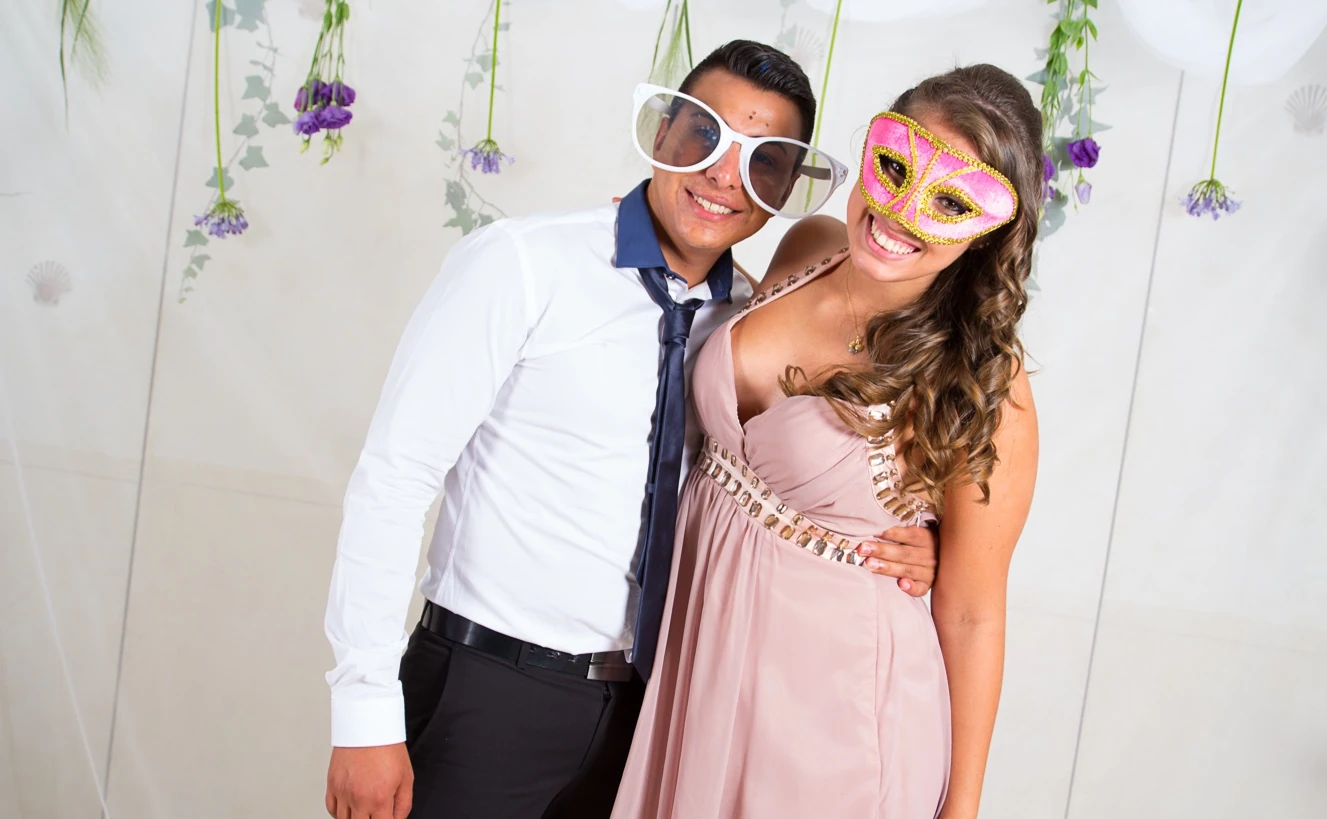 Wedding guests posing with oversized glasses