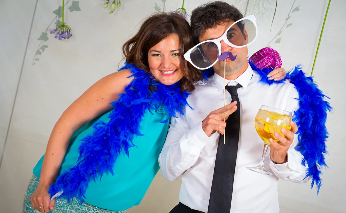 Wedding guests enjoying feather boas and playful props